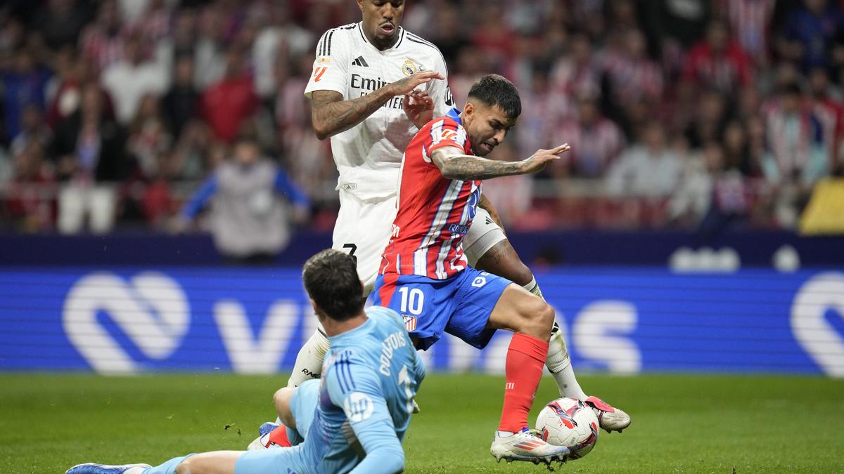 Real Madrid draws against Atletico in derby interrupted after objects thrown on the field